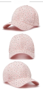 Close-up of pink baseball cap featuring delicate white floral lace and sparkling rhinestones