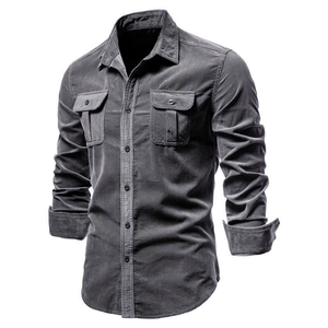 Detail of dark grey corduroy shirt with double chest pockets and visible fine texture