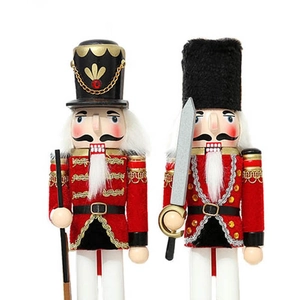 Detail of wooden nutcracker pair in red velvet uniforms with sword and scepter