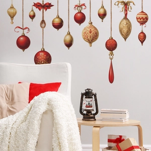 Christmas wall decal with red and gold vintage ornaments hanging above a cozy white sofa