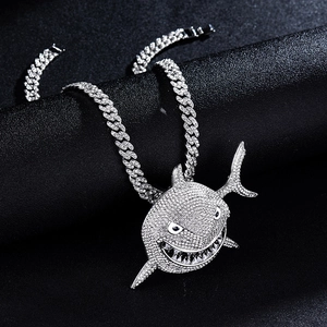 Macro detail of silver tennis chain with iced-out shark head pendant and rhinestones