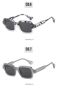 Detail view of square frame sunglasses in marble and transparent grey at 45 degree angle