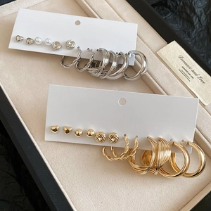 Close-up of a 12-piece mixed gold and silver earring set with hearts and hoops