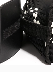 Close-up of black and white woven tote bag featuring checkered pattern and velcro strap