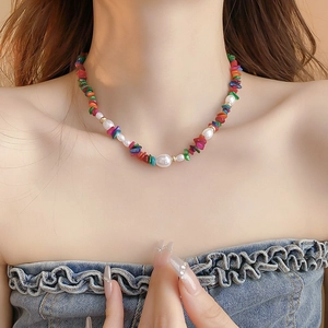 Colorful irregular stone and faux pearl beaded choker necklace worn by a female model