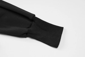 Detail of the black ribbed knitted cuff showing professional stitching and fabric texture