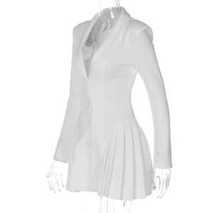 Detail showing the pleated hem and tailored waist of a white blazer dress