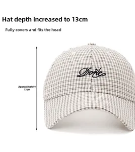 Detail of plaid baseball cap showing 13cm depth and Dorte embroidery texture