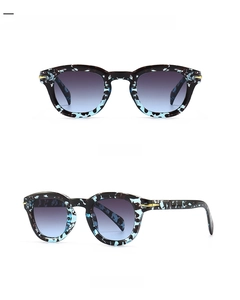 Detailed front and side view of round blue camouflage vintage sunglasses with grey gradient lenses
