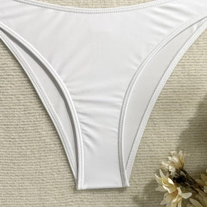 Detailed close-up showing the precise double-needle stitching on white bikini bottom