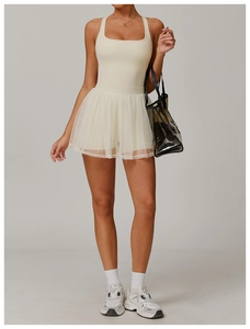 Detail view of cream white tennis dress with layered tulle skirt and square neckline