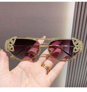 Detailed macro view of butterfly diamond inlay and golden metal frame on sunglasses