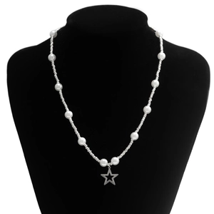 Detail of white faux pearl necklace with silver beads and a star pendant on black velvet