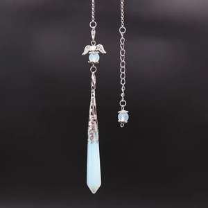 Detail view of silver angel wing pendant with moonstone bead and hexagonal crystal point