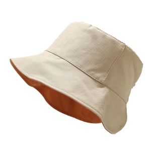 Cappello da sole reversibile minimalista in tela beige e arancione con tesa ondulata