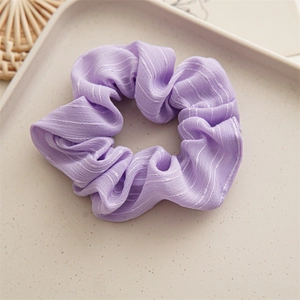 Macro detail of lavender chiffon scrunchie with white vertical stripes and soft pleats