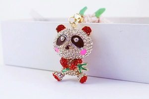 Detailed view of panda keychain featuring sparkling rhinestones and a bamboo accessory