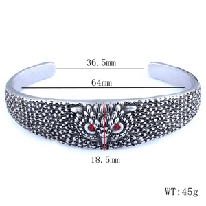 Detailed view of Nordic owl stainless steel bangle with red stones and size specs