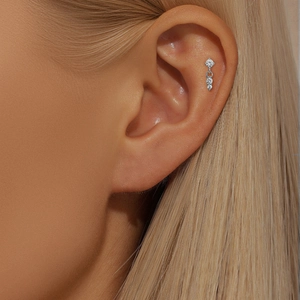 Close-up of S925 sterling silver ear bone stud with dangling star and vertical zirconias