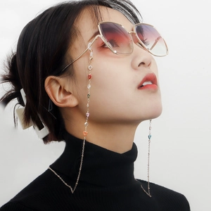 Chic eyewear chain with colorful enamel hearts and gold metal link on female model