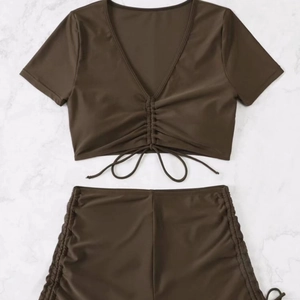 Flat lay of a two-piece coffee brown bikini set with V-neck top and drawstring details