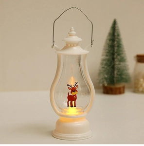 Close-up of white LED Christmas lantern with reindeer motif and warm glowing light