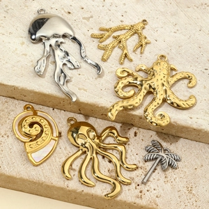 Golden and silver stainless steel ocean themed charms including jellyfish and coral