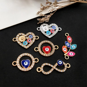 Evil Eye charm set with heart and leaf shapes in gold and silver finish with rhinestones