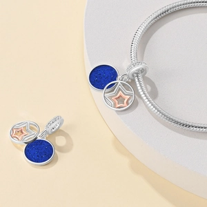 Silver space travel charm with blue glitter disc and rose gold star for bracelets