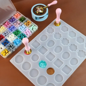 Detail of multi-shape silicone mold for wax seals featuring 24 geometric cavities