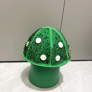 Macro detail of mushroom shaped handbag with green crystal rhinestones and white dots