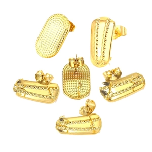 Golden oval stainless steel earrings with dot texture and embossed stripes on white background