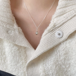 Elegant 925 sterling silver teardrop necklace for women shown on a beige knitted sweater