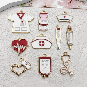 Flat lay of colorful enamel medical charms including nurse hats, stethoscopes and syringes