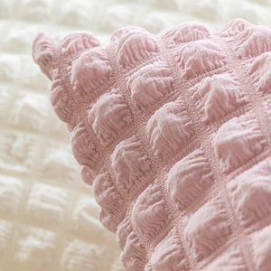 Pink waffle knit throw pillow cover with soft texture and minimalist puff grid pattern