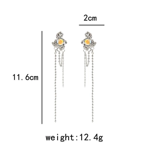 Long silver tassel earrings with yellow cabochon beads and size measurement markers