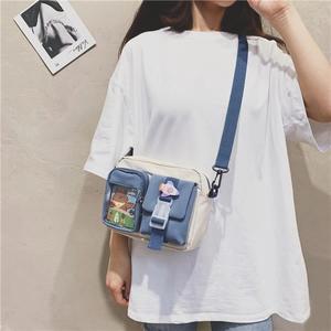 Detail of canvas crossbody bag showing transparent pocket with cartoon bear illustration