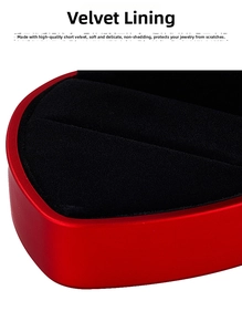 Macro detail of the soft black velvet lining inside a red heart-shaped jewelry box