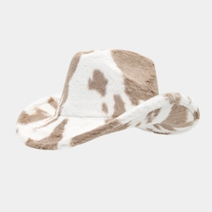 Detailed view of plush western cow print cowboy hat with thick brown and white faux fur texture