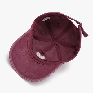 Unstructured burgundy baseball cap with white heart embroidery on the underbrim