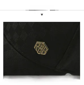 Close-up of black plaid baseball cap with RZG vintage brass logo and textured fabric