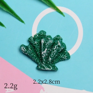 Close-up of a green resin coral-shaped DIY accessory with white texture and dimensions