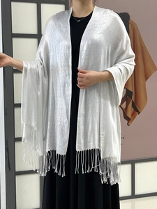 Detail of silver metallic shawl with shimmering thread and long fringe trim for party