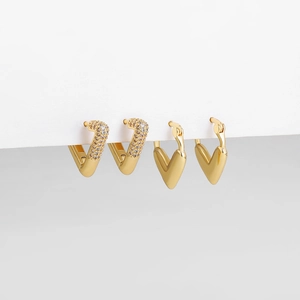 Close-up of 18K gold heart hoop earrings with cubic zirconia and polished finish