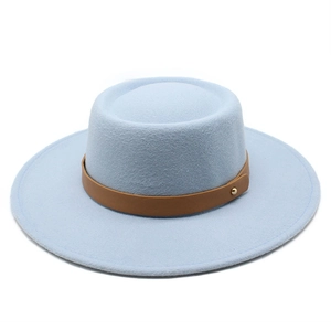 Macro shot of light blue wool boater hat with brown leather band and golden buckle