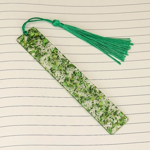 Handmade rectangular clear acrylic bookmark with green foil flakes and matching silk tassel