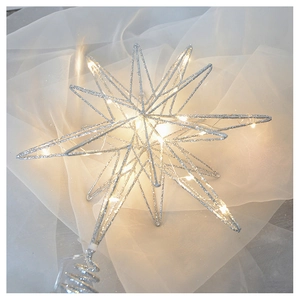 Detailed view of silver glitter star tree topper with warm white LED lights on metal frame