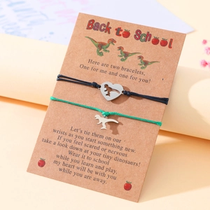 Back to school stainless steel dinosaur heart bracelets with woven cords on a message card