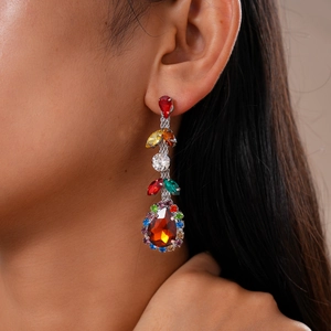 Detail view of luxury zircon leaf drop earrings with colorful crystals and pear red stone