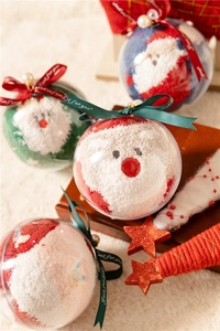 Close-up of Santa Claus coral fleece socks inside a festive transparent gift ball ornament